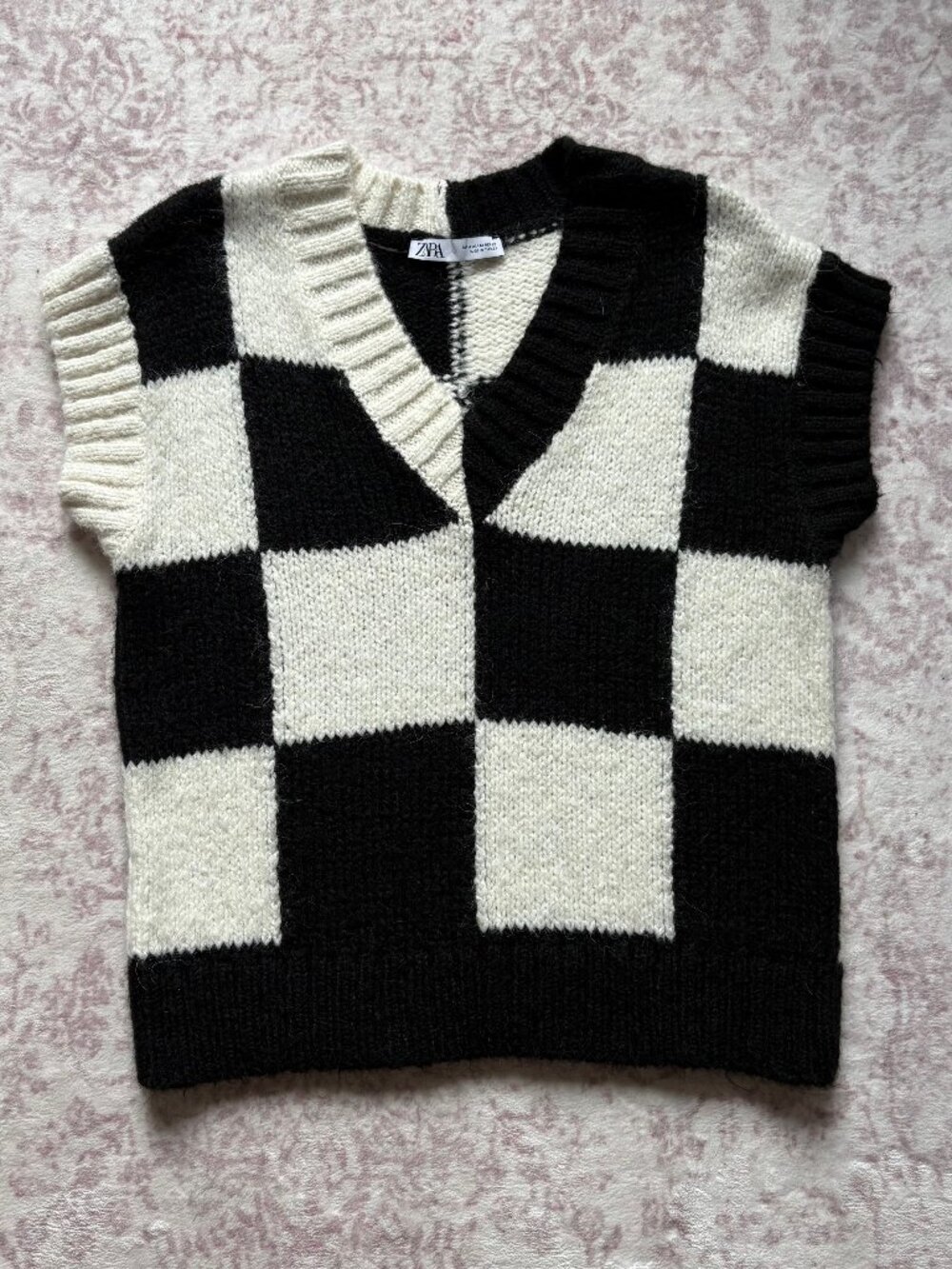Zara black and white checkered sweater vest from Wednesday